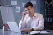 © Africa Studio - Handsome young man suffering from headache while working in office