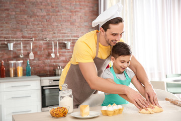 Wall Mural - Dad and son cooking at home