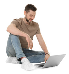 Wall Mural - Handsome young man with laptop on white background