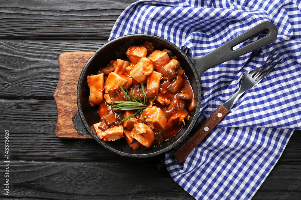 Frying pan with chicken cacciatore on kitchen table