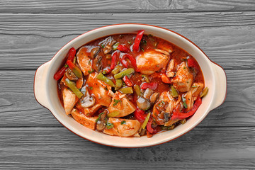 Wall Mural - Delicious chicken cacciatore in baking dish on kitchen table