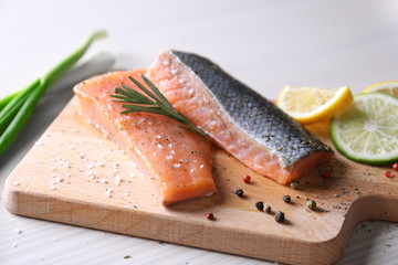 Freshly marinated salmon fillet on wooden cutting board