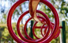 Red Monkey Bar Climbing And Hanging Rings In A Shallow Depth Of Field