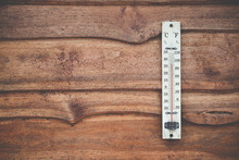 Wood Thermometer Calibrated In Degrees Celsius On The Wooden Wall, Concept Of World Hot And Weather.