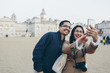 © FOLIO - UK, England, London, Mid adult man and woman taking selfies with Horse Guards Parade in background
