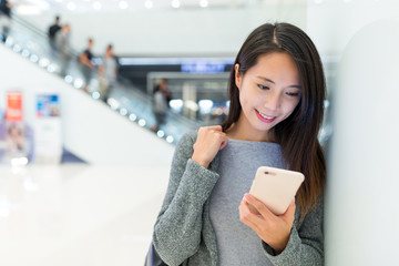 Wall Mural - Woman use of cellphone in shopping mall