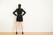 © PR Image Factory - Rear view of businesswoman looking at on wall