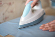 © sata_production - Woman tailor ironing textile with steaming on the iron board before starting work