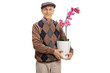 Senior with an orchid flower in a pot