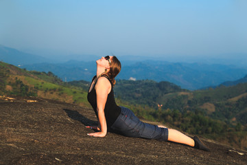 Wall Mural - Woman practicing yoga outdoors.