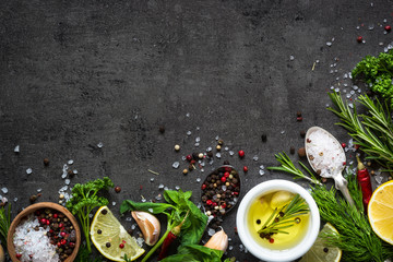 Wall Mural - Selection of spices herbs and greens. Top view black background. Cooking ingredients