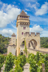 Summer view of medieval stone Valentre Bridge with vineyard in Cahors, France