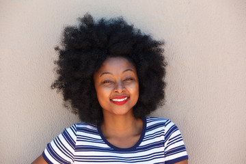 Wall Mural - beautiful young black woman smiling with striped shirt