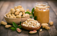 Peanut Butter And Peanuts On The Wooden Table