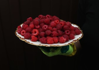 Red fresh Ruspberry on  the  plate in  the  summer 