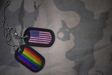 Wall Mural - army blank, dog tag with flag of united states of america and gay rainbow flag on the khaki texture background. military concept