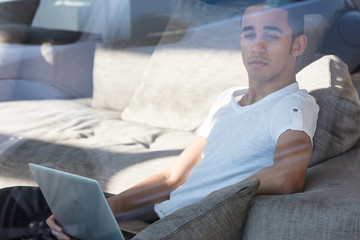 Sad man with laptop looking away