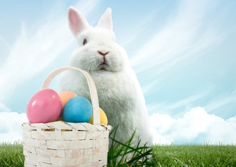 Poster - Easter rabbit with basket of eggs in front of blue sky