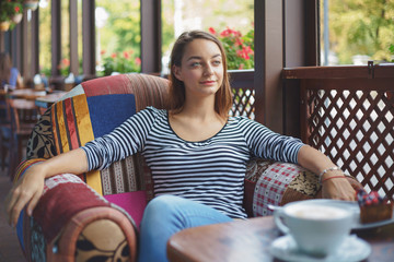 Wall Mural - Young woman sitting indoor in urban cafe