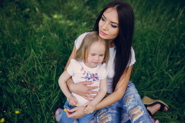 child near tree with mom