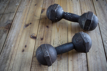 The old dumbbell on the wooden floor.