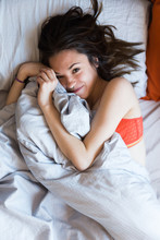 Beautiful Girl Cuddling In Bed
