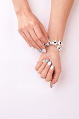 Fotomurales - Beautiful manicure. Cute floral bracelet.