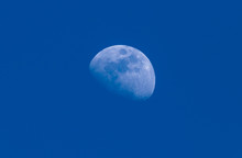 Early Morning Moon In A Waxing Gibbous Phase In The Blue Sky Background. Detailed Craters. Centered. Copy Space.