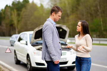 Wall Mural - Couple near broken car on a highway roadside