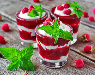 Raspberry dessert with cream in a glass