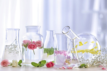 Wall Mural - Beautiful composition with perfume samples and flowers on table