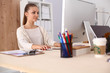 © shefkate - Young woman working in office, sitting at desk