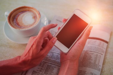 Poster - Man using mobile phone by coffee and newspaper in cafe