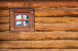 Small window on the wooden wall