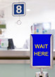 © milkovasa - sign with text WAIT HERE before counter