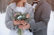 © Africa Studio - Happy wedding couple with bouquet outdoors on winter day, closeup