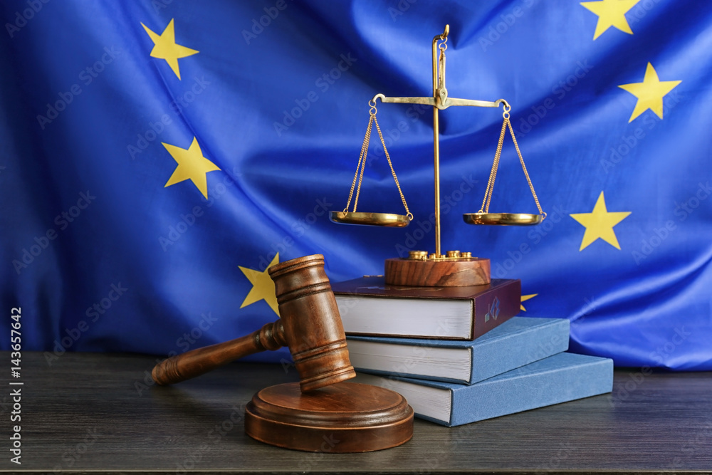Judge gavel and books with scales on European Union flag background - obrazy, fototapety, plakaty 