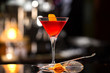 © Mayatnikstudio - Closeup glass of Manhattan cocktail decorated with orange at bar counter background.