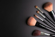 Set Of Flat Top View Of Various Professional Female Cosmetics Brushes For Makeup Isolated On Black Background, Cosmetics Concept, Makeup Concept, Copy Space Image For Your Text, Flat Lay.