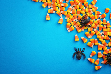 Sticker - Tasty Halloween candies on color background