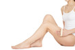 © Nestor - Respect your body. Cropped shot of a beautiful young female posing at the studio using a body scrub massaging her legs on white background copyspace on the side.