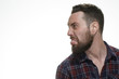 © Nestor - Why too serious? Shot of a bearded man looking at the copyspace sticking his tongue out at the studio isolated on white.