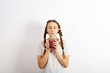 Enjoy a young woman with pigtails, drinking a delicious smoothie