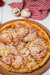 Hot true ITALIAN PIZZA with salami and cheese. TOP VIEW Tasty traditional pepperoni pizza on board on white wooden table with decoration. Copy space for your logo. Ideal for commercial

