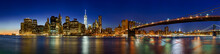 Panoramic View Of Lower Manhattan Financial District Skyscrapers At Twilight With The Brooklyn Bridge. New York City