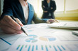 © Freedomz - Business adviser analyzing financial figures denoting the progress in work of company, business concept.