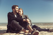 © svitlychnaja - Young hipster couple in stpring sunny day posing on the beach. Interpersonal relationship. Couple in love.