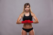 © satyrenko - athletic girl posing in red bandages, isolated on the grey background boxing fighter kickbox