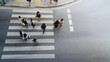 people walk and watch on crosswalk street at the top view of city street. (aerial view)