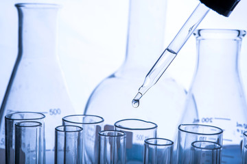 Wall Mural - dropping chemical liquid to test tubes, laboratory research and development concept